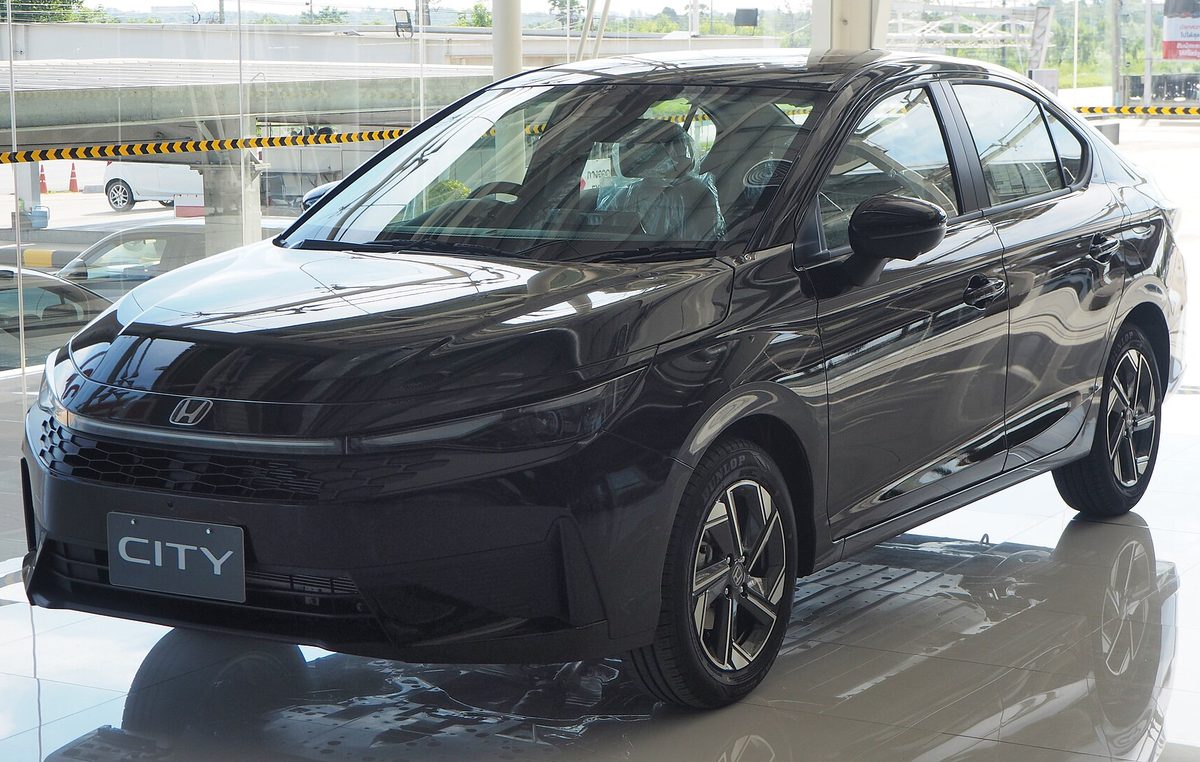 Honda City e:HEV in black in a dealer showroom in Thailand, front three-quarter view