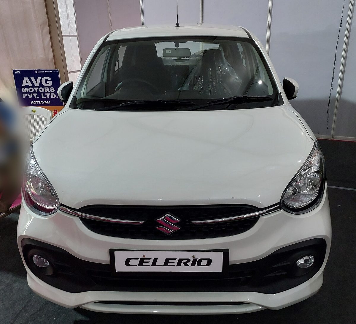 Maruti Suzuki Celerio in white at a dealer display, front view