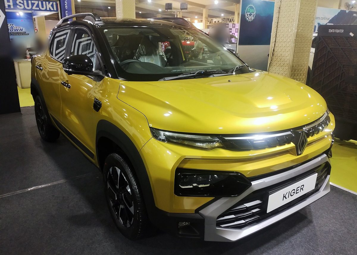 Renault Kiger in yellow with a black roof at an auto show, front three-quarter view