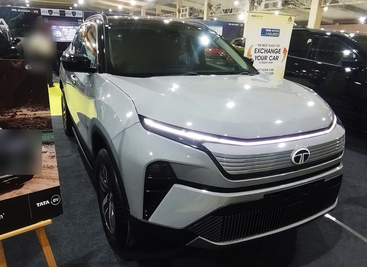 Tata Harrier EV in silver at an auto show, front three-quarter view